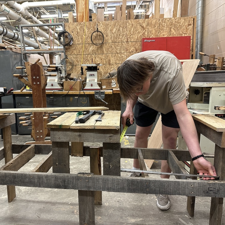 Payton Bridgeman turning some pallets into a bench with tables in Mr. Proehl's Early Bird Woods II #ilcte #dragonpride