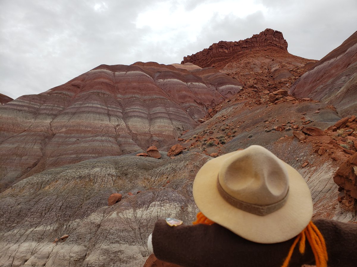 Ranger Sarah enjoys the colorful view. The Paria River has been carving its way through the Chinle Formation for millions of years. Over time, the river has eroded the rock, exposing the different minerals that create the canyon's stunning colors. -Grand Staircase-Escalante NM