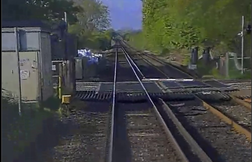 We’re investigating exactly what happened, but it appears that a car struck part the level crossing, breaking part of the barrier, and some of the debris on the track struck the train’s electrical pick-up equipment. This meant train had lost power and couldn’t move forward (2/3)