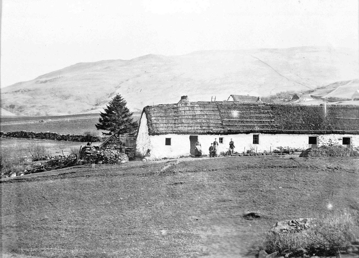 A group of people in front of a thatched house at Ardeonaig, near the southern shore of Loch Tay, undated [Highland Collection, @edcentrallib]