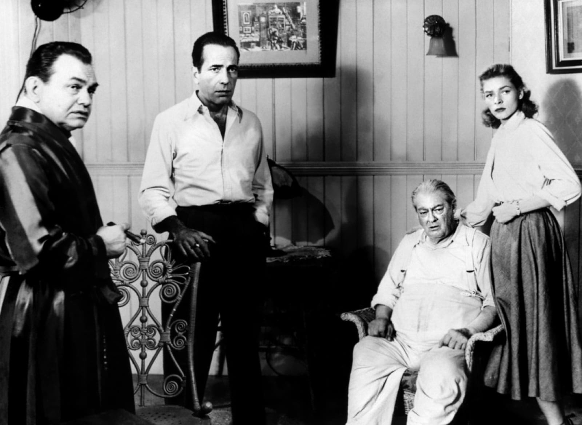 'You'd give your left arm to nail me, wouldn't you? You hick, I'll be back pulling strings to get guys elected mayor and governor before you get a ten buck raise.' Edward G Robinson, Humphrey Bogart, Lionel Barrymore, and Lauren Bacall working on John Huston's Key Largo.