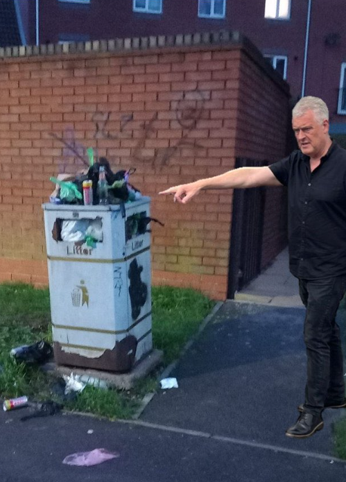 A dense unsightly container, in a public space, so full of shit it's overflowing. And a litter bin.