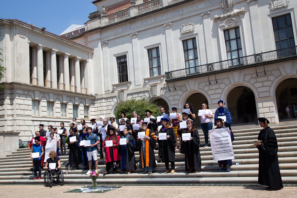 BREAKING: Roughly 40 faculty stand on the steps of the Tower holding a vigil for “scholasticide,” or the injury and killing of students and teachers in Gaza.