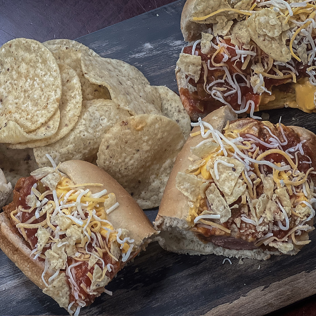 Check out this week's Hot Dog of the Homestand, the Cinco De Mayo Dog. This quarter-pound all-beef hot dog is loaded with seasoned chili, nacho cheese, salsa, and shredded jack cheese and topped with tortilla chips.