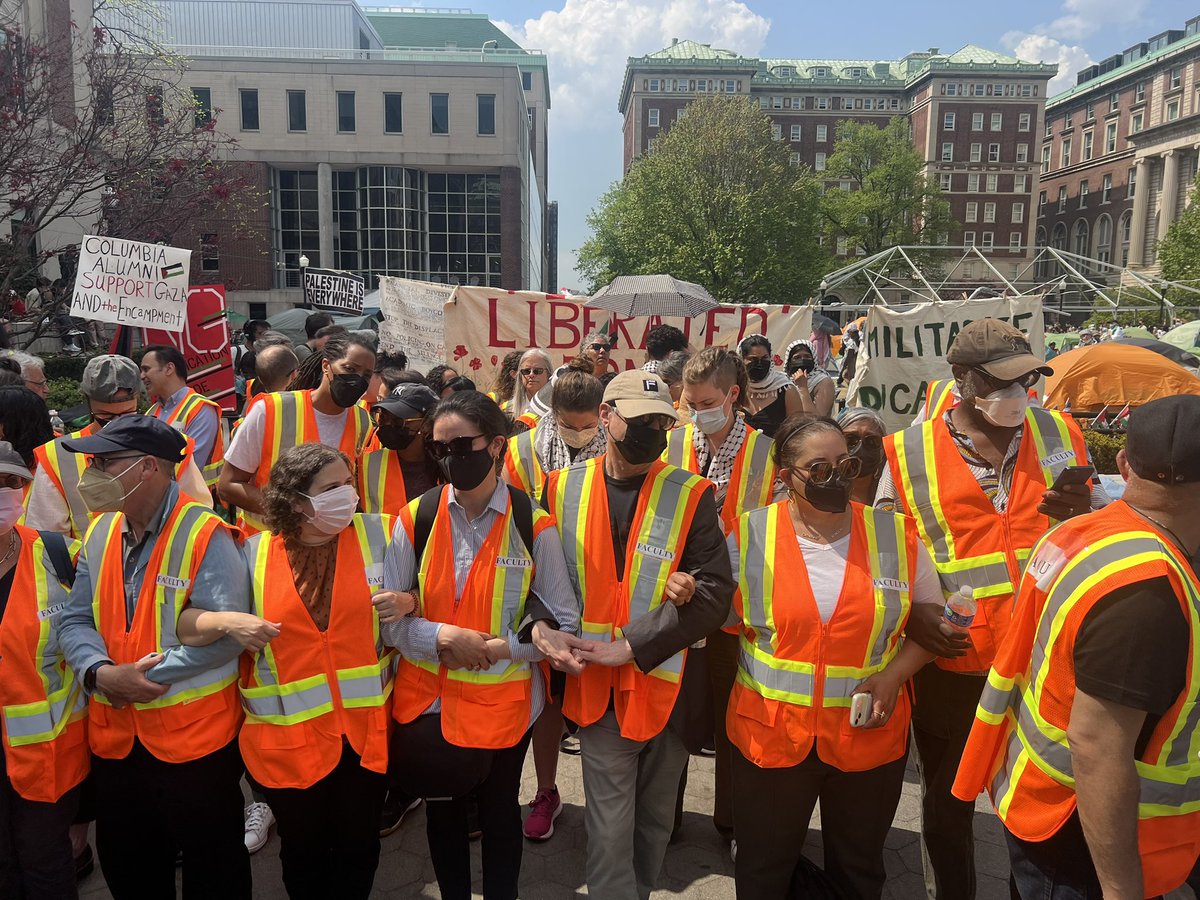 Columbia University faculty have linked arms at the entrance of the encampment as the 2p deadline passes for students to vacate or face suspension.