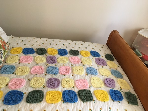 My Auntie May (1915-2010) crocheted these colorful squares, shown on a white background.  Her granddaughter just sent them to me to finish a baby blanket for a new granddaughter of mine, her great great-great-grandniece, arriving in July.  

I'm excited.