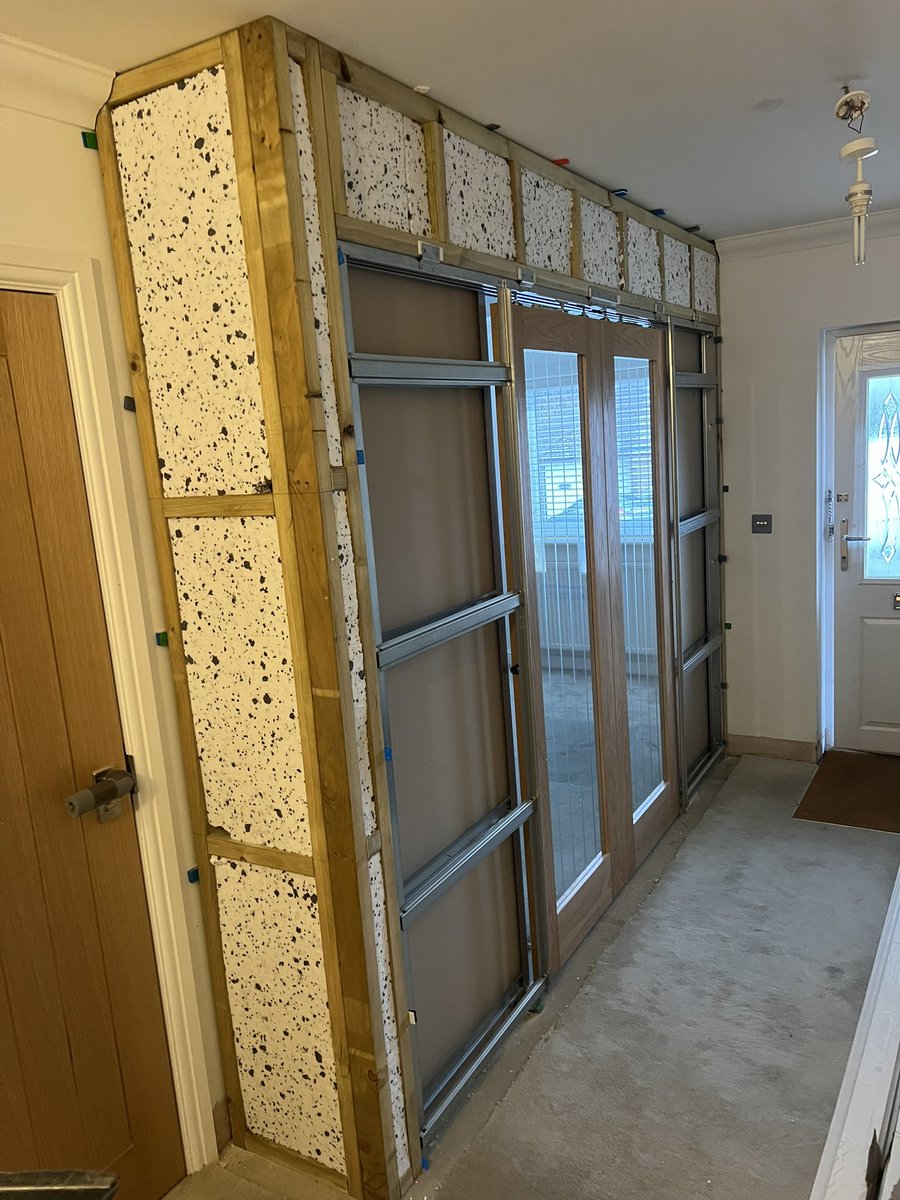 Stud partition wall built and double pocket doors installed #rwilsoncarpentry