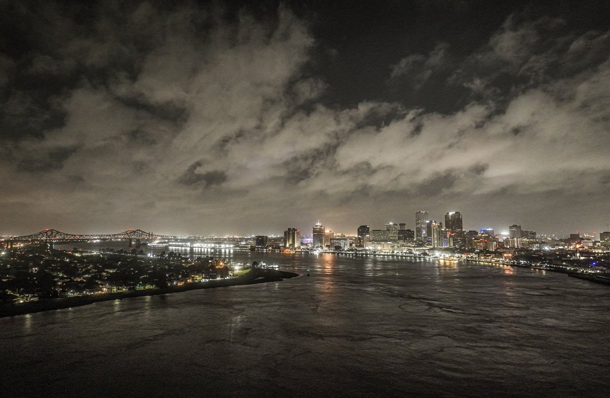 Light from clouds illuminates river vortices, New Orleans