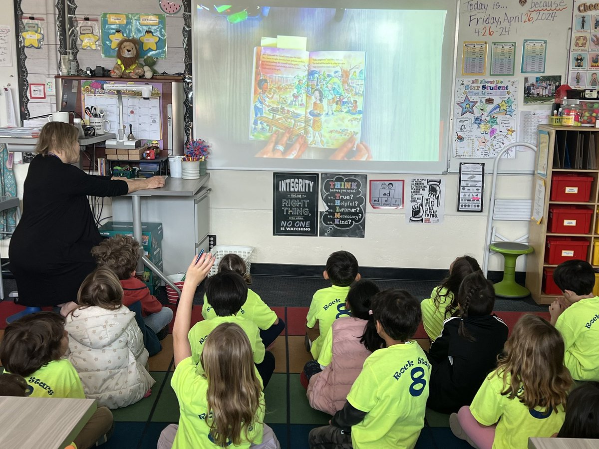 'Mrs. Mathewson's first graders are spellbound during a delightful read-aloud session! 📚🌟 Wide-eyed & captivated, they're exploring new worlds through the magic of storytelling. Building a lifelong love for books, one page at a time! #ReadingRocks #FirstGrade #Storytime