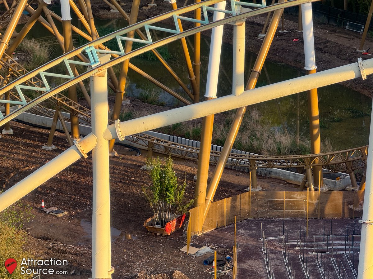 View from Colossus (during a lift hill walk) of water jets installed either side of Hyperia's splash down element. Larger trees staged awaiting planting.