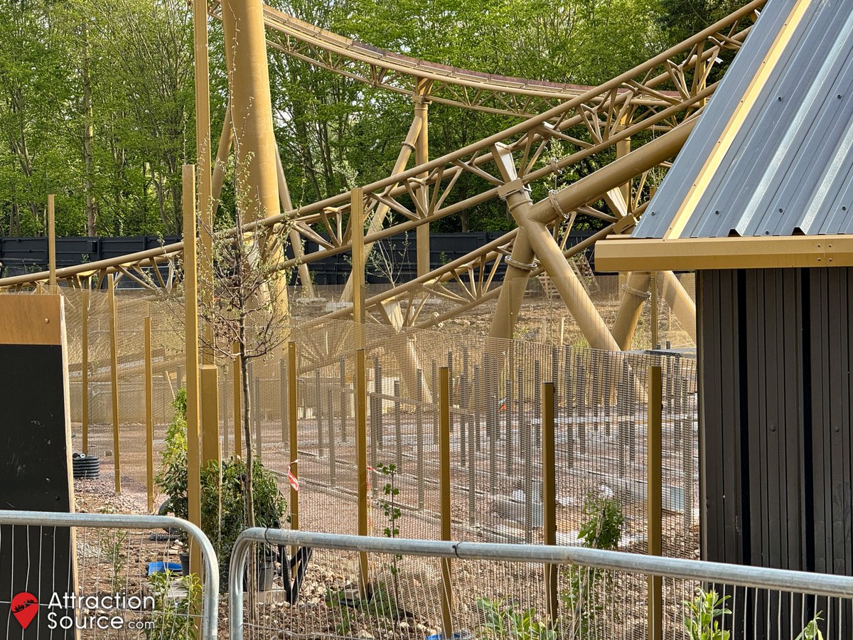 Ground level view of Hyperia's queue line taking shape. The perimeter / ride area fencing features a dense, anti-climb mesh design. Camera lenses may struggle to take photos through.