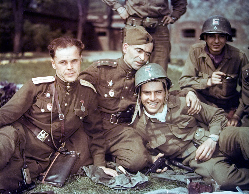 Soviet and US officers at Torgau, a city on the Elbe River, Germany, 28 Apr 1945; note left Soviet officer's TT-33, center Soviet captain's Luger in belt, right US Lieutenant Dwight Brooks's holstered Colt 1911 and in-hand Walther P38