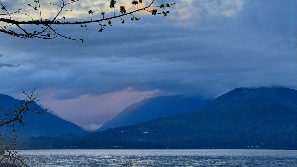 Imagine a breathtaking sunset slowly trying to peek through the misty valleys of the majestic Olympic Mountains. The sky painted in vibrant hues of orange and pink, creating a mesmerizing sight that will leave you in awe.