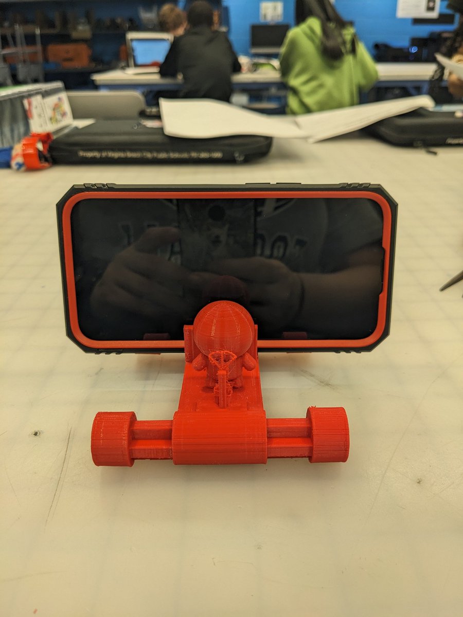 A student wanted a cell phone holder for their desk at home so I told him to make one. He turned to @tinkercad and next thing you know we have a cell phone holder! So proud of his determination to build it the way he wanted with his love of cars but also have a person drive