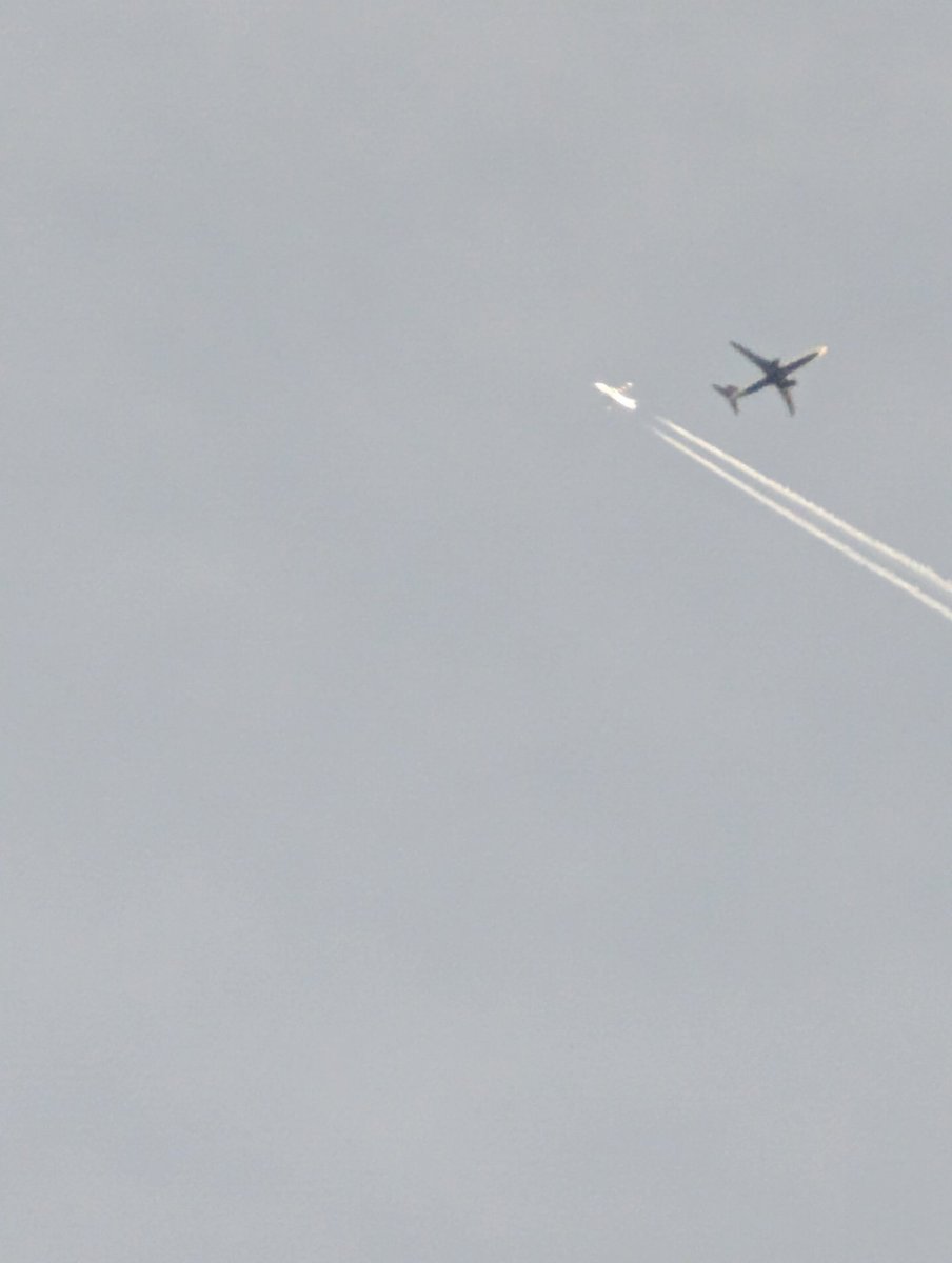 Lucky shot, using my handheld Pixel 7 Pro, to get a picture of the higher altitude jet at probably 20,000 feet (big zoom) and the lower plane, at probably 8,000 feet, came into the shot as I snapped the picture.