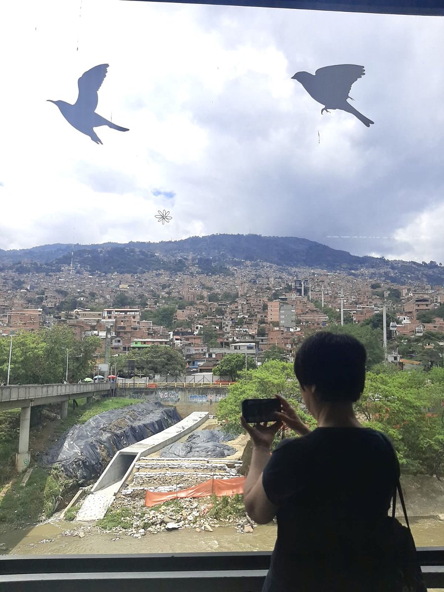 While I was taking a photo of the amazing scene from the Acevedo train/cable car station in #Medellín, #Colombia, my wonderful translator+travel guide+body guard+photographer took this photo of me. How do you like it? #freechinacolombia