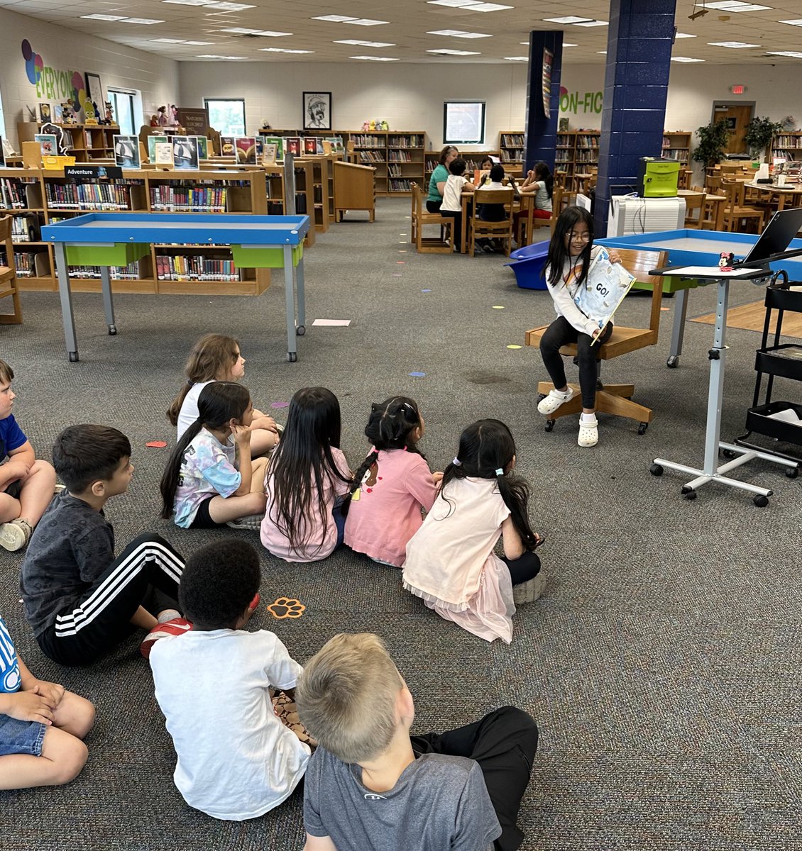 This girl bet on and won library assistant in our 3rd grade supply and demand auction. She looks so sweet doing a read aloud with kindergarten! Thanks Mrs. Miller for letting her help and Ms. Cleary for arranging all of this fun! @NatcherLibrary @katherinecleary @NatcherElem