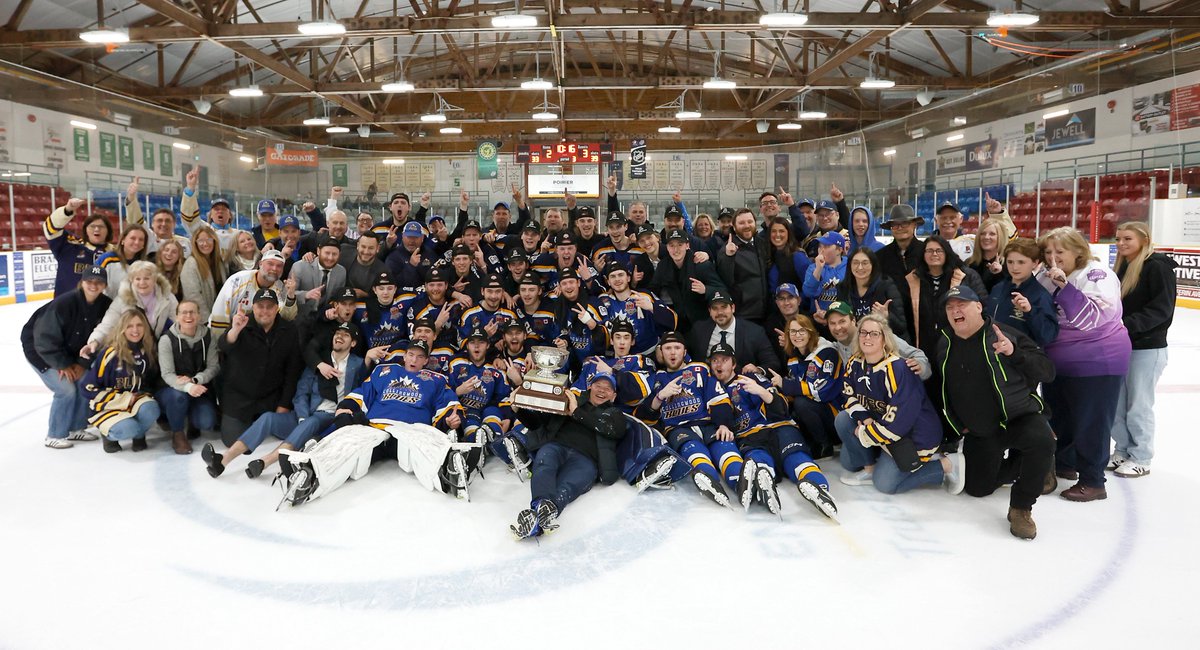 TRENTON, ON - APRIL 29: Members of the Collingwood Blues and their families and friends pose for a team photo with the Buckland Cup at the Duncan McDonald Memorial Community Gardens on April 29, 2024 in Ontario, Canada (Photo by Tim Bates / OJHL Images)