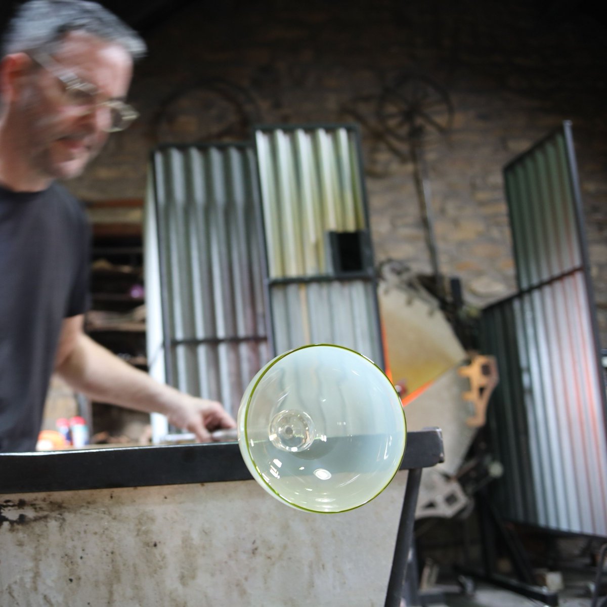 Stephen making a Wild Garlic bowl, the blank piece is still hot here. Once cold Kate starts the engraving process.