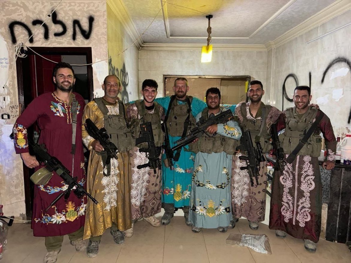 Israeli soldiers take macabre trophy photos with the toys and clothes of Palestinian women and children who have been ethnically cleansed and possibly murdered. Look at their smug, self-satisifed faces.