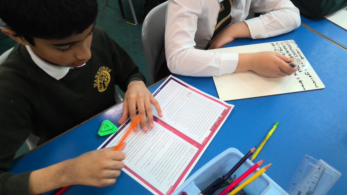 Year 5 hard at work identifying writing skills in our model text.