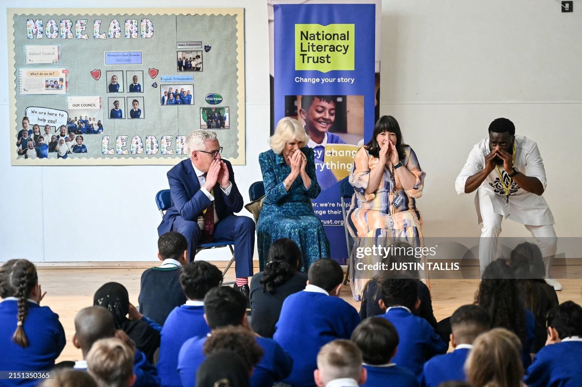 Queen Camilla listens to British-Sierra Leonean rapper and storyteller Alim Kamara at Moreland Primary School