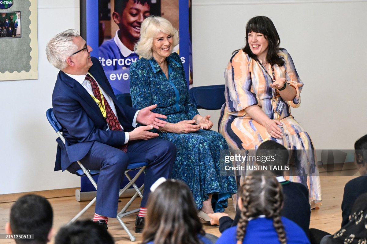 Queen Camilla, @MorelandPrimary Headteacher Catherine Lawrence and National Literacy Trust's Chief Executive Jonathan Douglas react during a performance by British-Sierra Leonean rapper and storyteller <a href="/alimKamara/">Alim Kamara</a>.