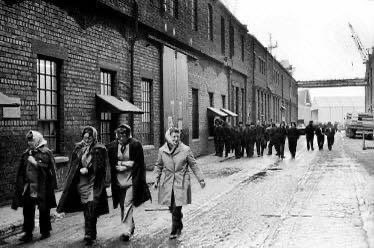 A photograph of Women workers leaving the Govan Shipyard after their shift in 1976.