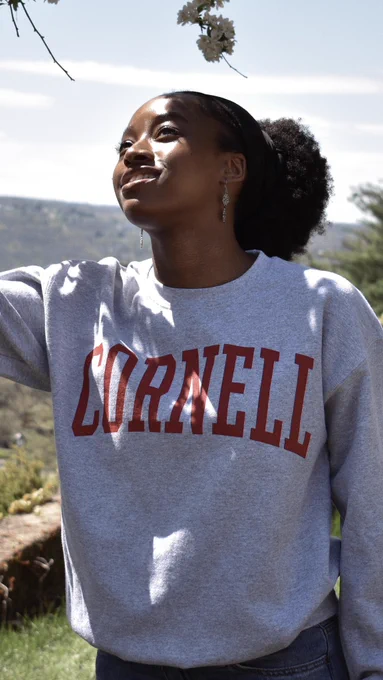 A Cornell Store model wearing a grey classic Cornell crew, available in-store only at The Cornell Store (Ho Plaza) on Tuesday, May 7.