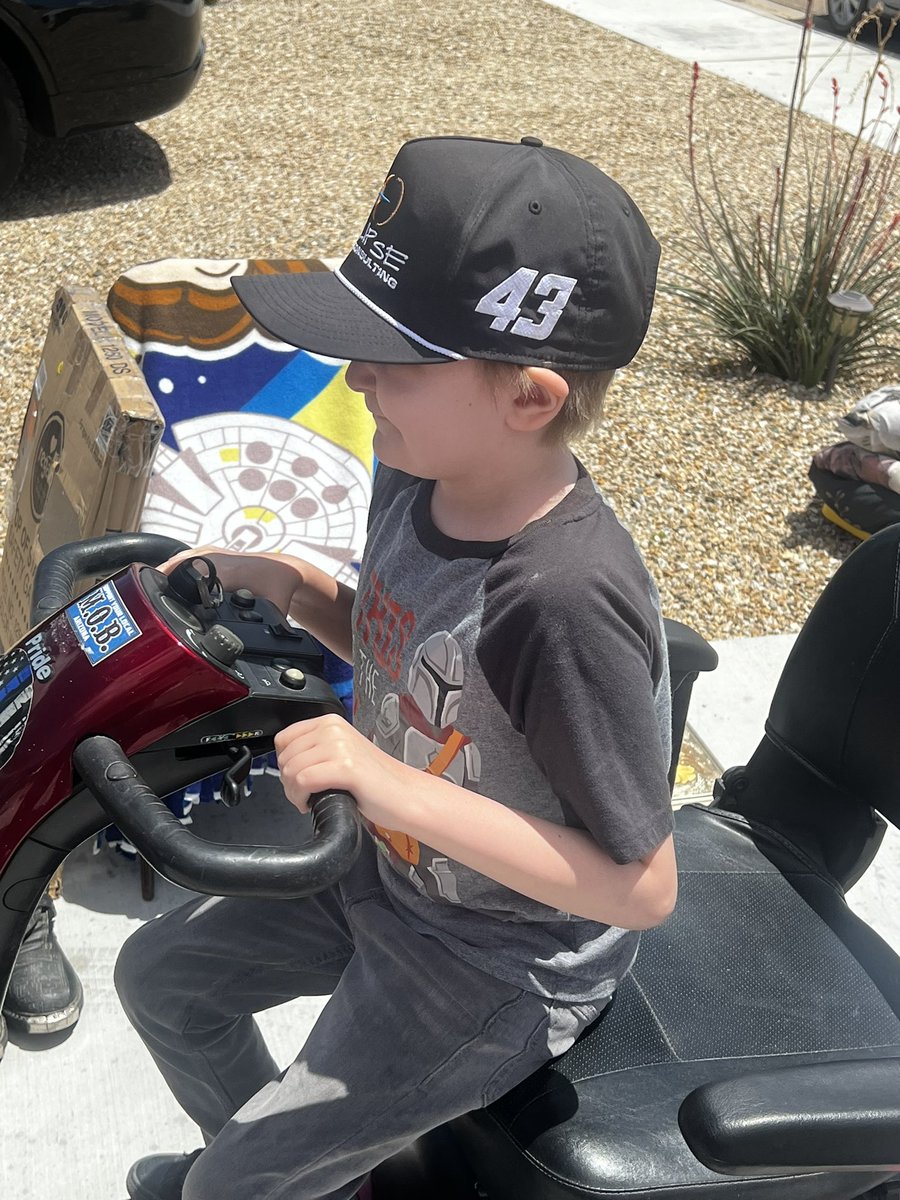 Zachery helping at the yard sale😂 He wouldn’t get out of the scooter! He was racing the neighbors kids on their bikes! This kid loves to go fast! ❤️#43 #ZacheryStrong #LeukemiaWarrior #ChildhoodCancer