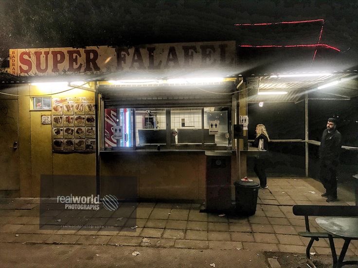 People wait for food at a falafel shop in Malmö, Skåne, Sweden. Gary Moore photo. Real World Photographs. #photojournalism #sweden #world #photography #food #malmo #garymoorephotography #realworldphotographs #people #cities #night #travel #images #travel