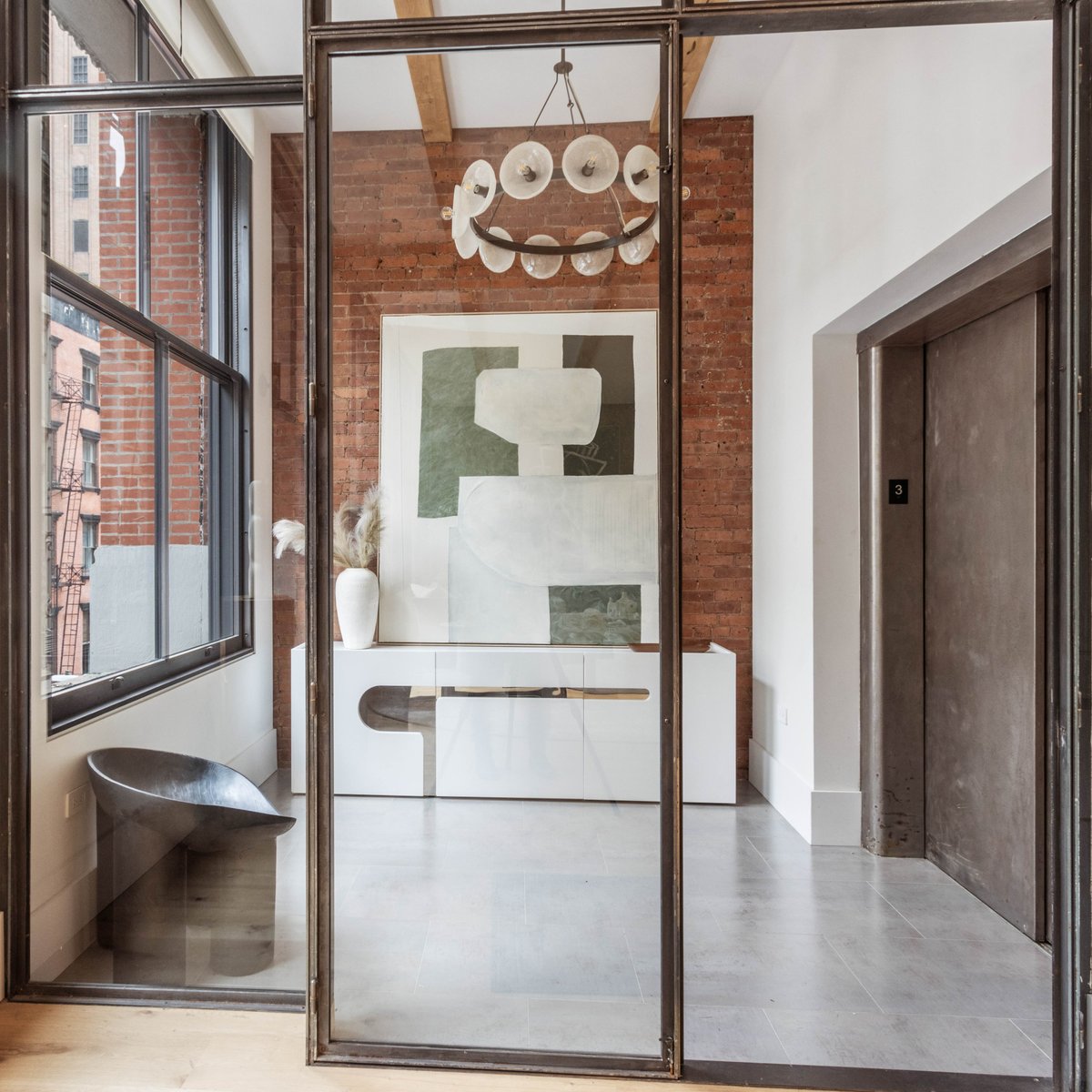 The blackened steel and glass foyer wall in our gut renovated Tribeca Loft beautifully fabricated by Parke Macdowell adds a modern touch to the space. #ZHarchitects #Architecture #Moderndesign #highendresidential #NYC #TribecaLoft #renovation #interiordesign 🏙️🛠️