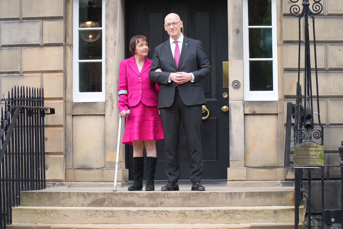 New First Minister @JohnSwinney at the door of Bute House with his wife Elizabeth Quigley