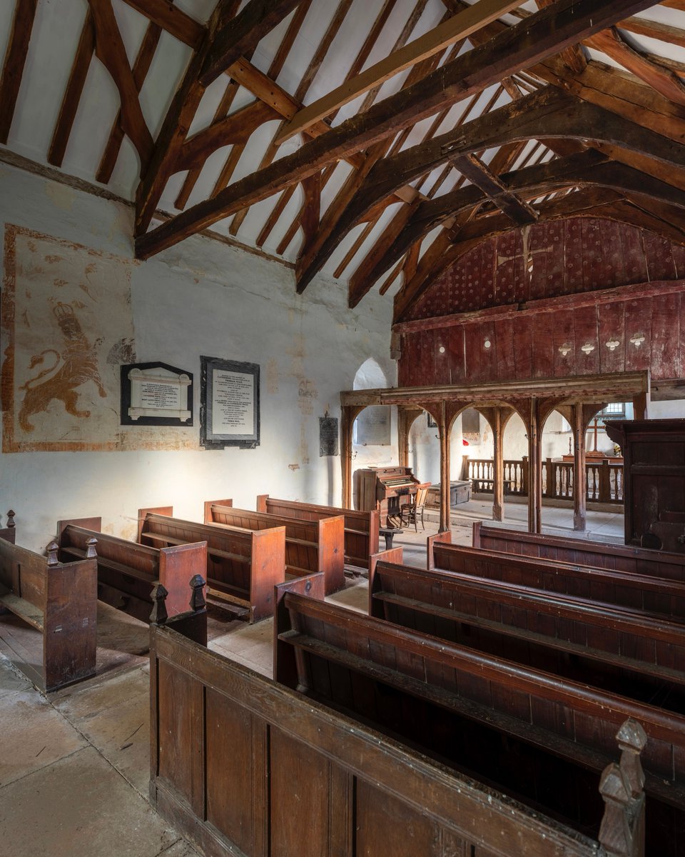 St Ellyw’s, Llanelieu is renowned for its huge 14th-century rood screen and loft. The wooden panels are painted red and decorated with stencilled white roses. In the centre, the white cross remains as a ghostly reminder of the former rood that once stood on the rood beam.