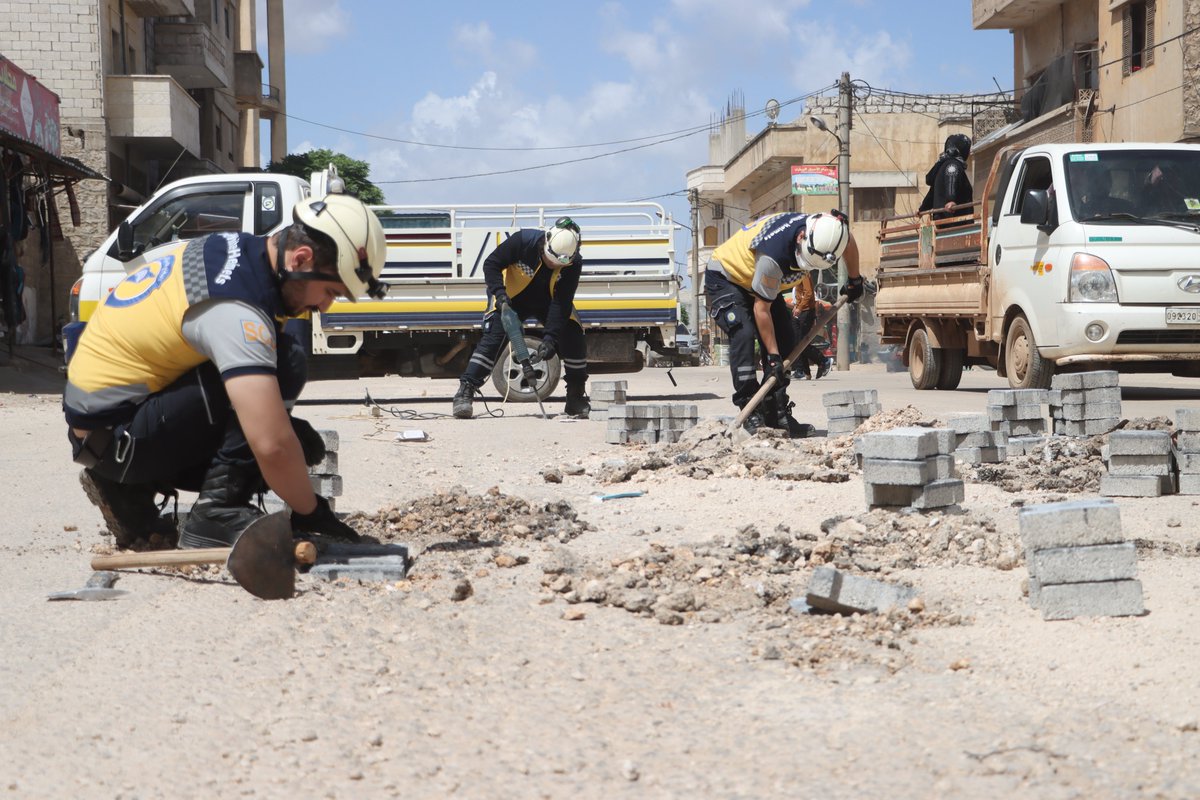 In an effort to facilitate civilian movement and reduce traffic accidents, our teams are repairing potholes and paving them with interlocking stones on the roads of Maarat Misrin city, north of #Idlib, #WhiteHelmets #Syria