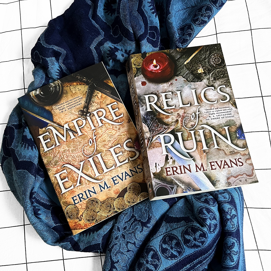 Continue the captivating trilogy featuring an unlikely team who must find a way to work together and solve an empire-spanning mystery to defend the last place they call home. RELICS OF RUIN, sequel to Empire of Exiles by @erinmevans, is available now from Orbit US!