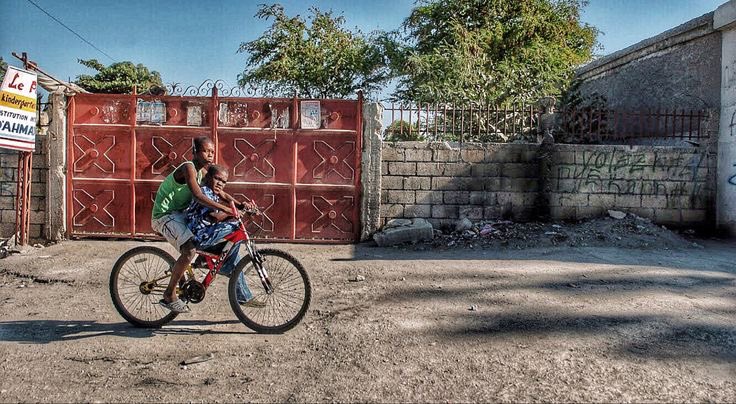 Two boys ride on a Port-au-Prince street. Haiti. Gary Moore photo. Real World Photographs. #photojournalism #haiti #children #portauprince #sweden #malmo  #garymoorephotography #realworldphotographs #nikon  #photography #people #travel #places