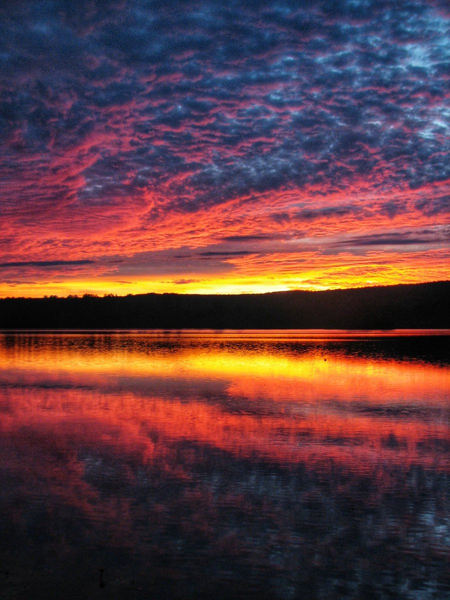 Here is an amazing, fiery looking sunset on our lake in Northeastern Minnesota!🌅💛🧡❤️ #sunset #sunsetphotography #tuesdayvibe