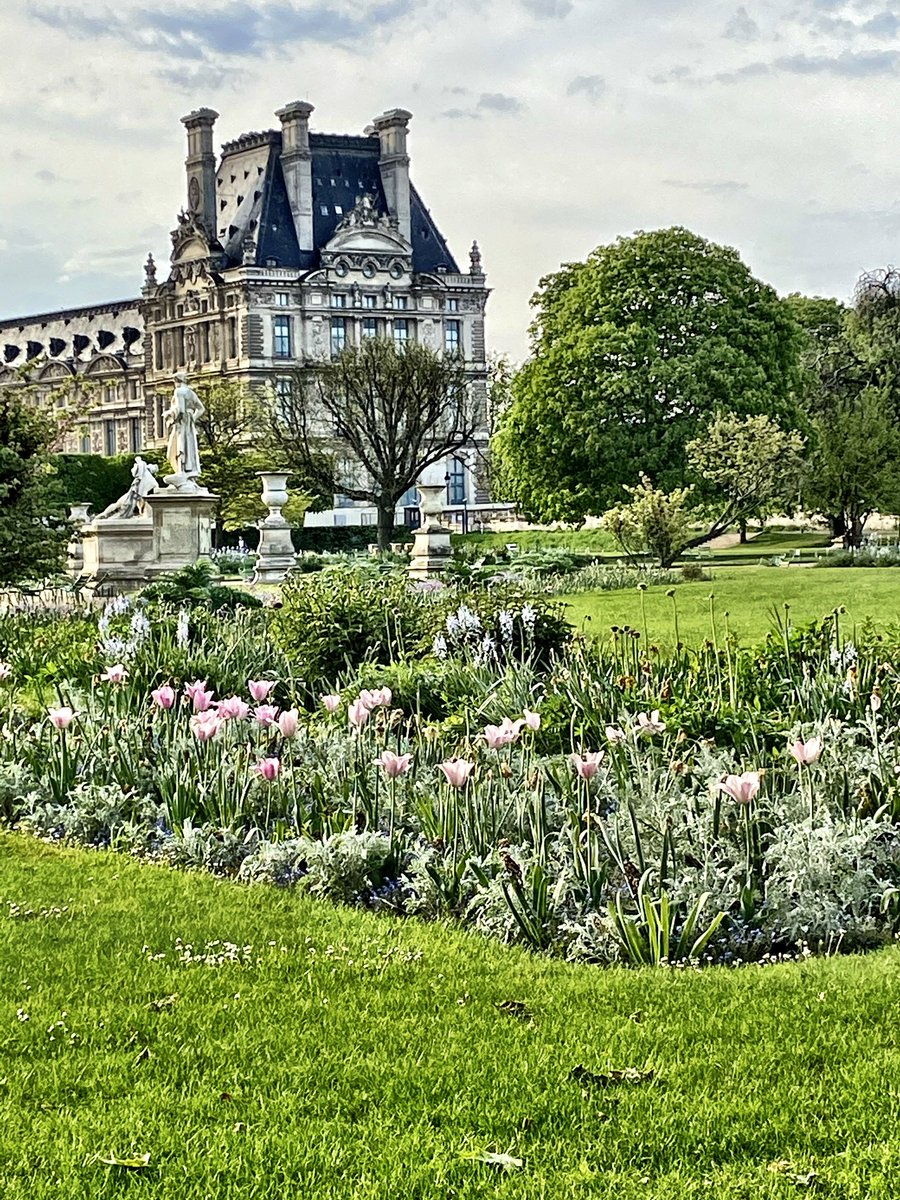 Spring in the Tuileries Garden with a portion of the Louvre Museum behind.