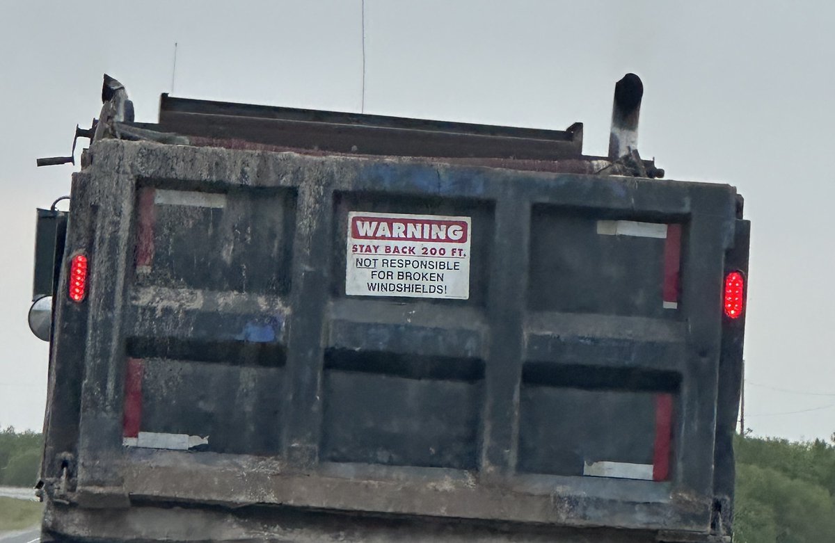 You should know. These signs don’t mean shit legally

If a truck drops a rock, and it cracks your windshield and you have dashcam footage of the event or even a photo of the truck with a poorly secured load, they’re going to pay it
Take them to small claims if you have to, easy $