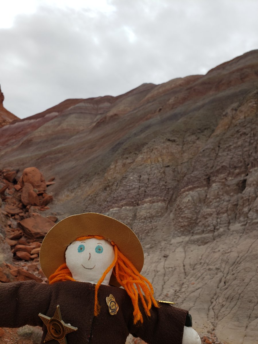 Ranger Sarah & colorful Paria Mountains. The mountains comprise various sedimentary rock layers, each representing different geological periods. These layers have been deposited over 85 million years, creating a rich tapestry of colors & textures. — Grand Staircase-Escalante NM