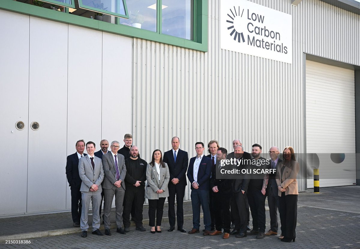 The Prince of Wales  poses for a group photo during his visit to Low Carbon Materials in Seaham