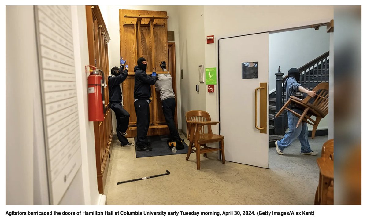 'Agitators' or terrorists, I guess it is all about context. In this case the context is masked people taking over a building by force and destruction which is slightly more than agitating (to arouse and raise concern).