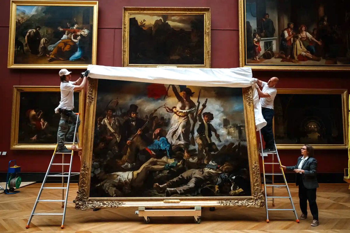 Louvre staff return the painting 'La Liberté guidant le peuple' by Eugène Delacroix to the gallery, after six months of restoration work...