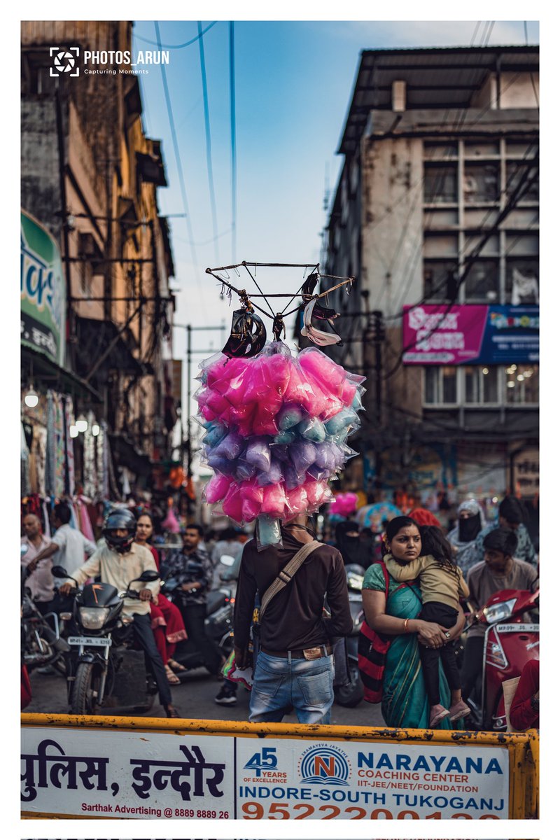 The cotton candy vendor, amidst a bustling marketplace, endeavors to capture d attention of potential customers. Wid determination and resilience, they strive to earn a modest living in a highly competitive environment! #hustle #Indore #StreetPhotography #SonyA7iv #ThePhotoHour