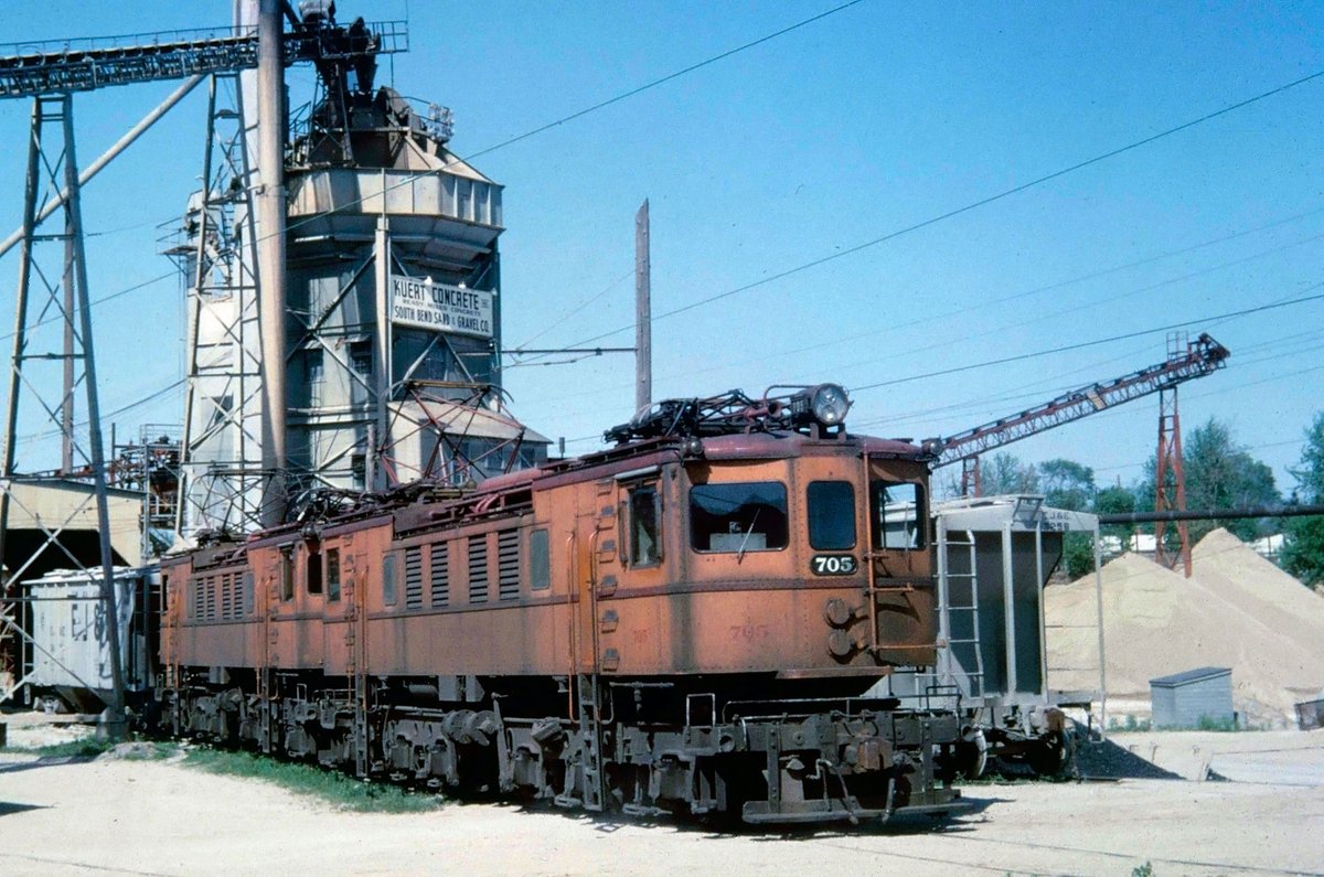 A pair of South Shore R-2 boxcab electrics, #705 and #704, switch out Kuert Concrete in South Bend, Indiana on May 10, 1964. american-rails.com/csssb.html