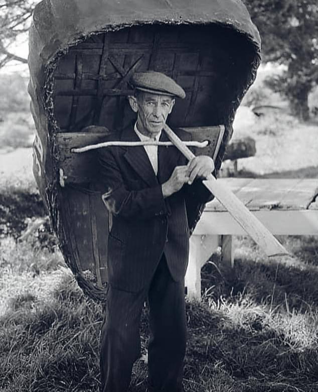 A Coracle Fisherman poses with his boat, on the banks of the Teifi River, Wales, 1950s.
>FH