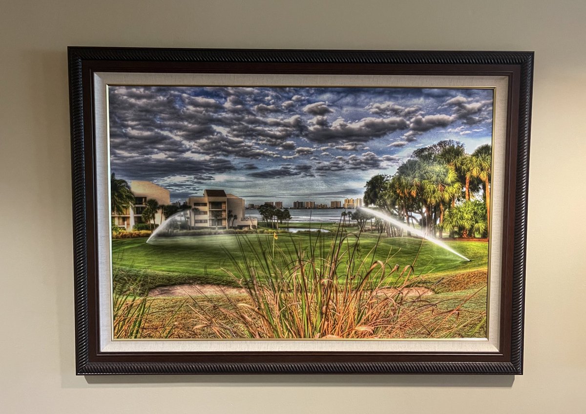 It might be the Mona Lisa of golf course paintings. The use of the sprinklers just frames the image so well. I joke because I love my club:)