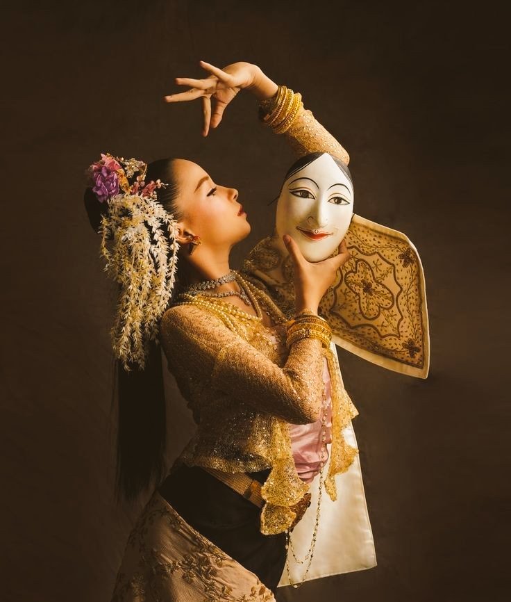 Burmese traditional attire with mask. Each movement is unique, imparting symbolic currents.
