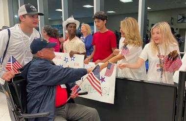 Students and teachers from Lorenzo Walker Technical High School helped to welcome home nearly 100 United States Veterans from Saturday's Honor Flight at RSW.